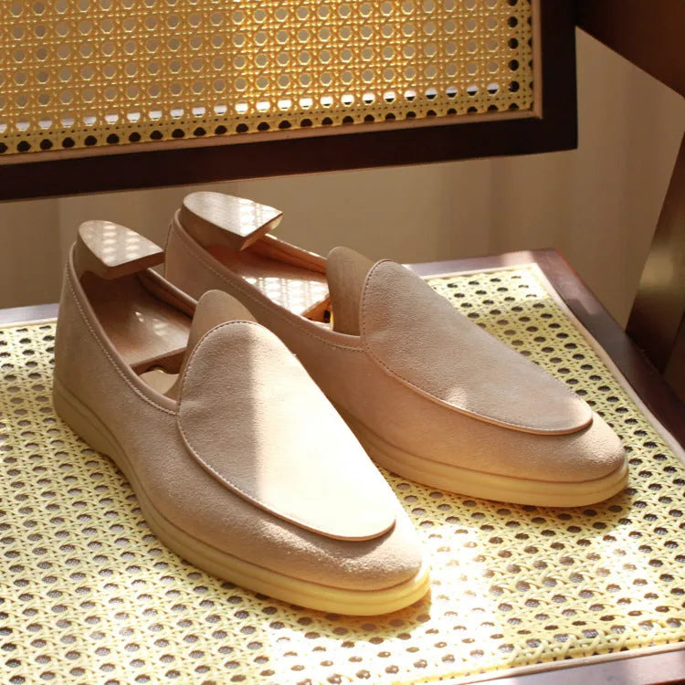 Men's brown genuine leather handmade loafers on a white background.