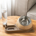 Brown elevated cat bowl set with automatic water bottle and curved food dish