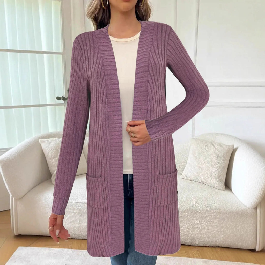 A woman's long sleeve loose-fit knitted cardigan jacket with pockets in wine red.