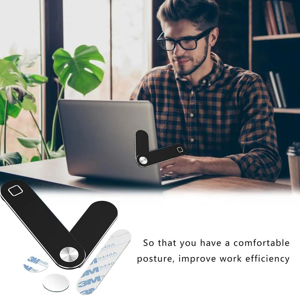 Black aluminium laptop phone holder with magnetic mount attached to laptop edge