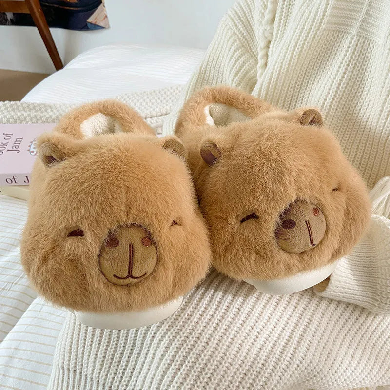 Light brown women's winter slippers with cartoon pattern, plush upper, and round toe.