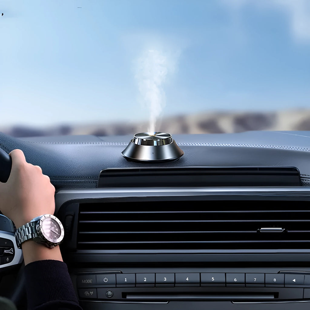 Black metal butterfly design car aromatherapy air purifier with USB cable and essential oil bottle.