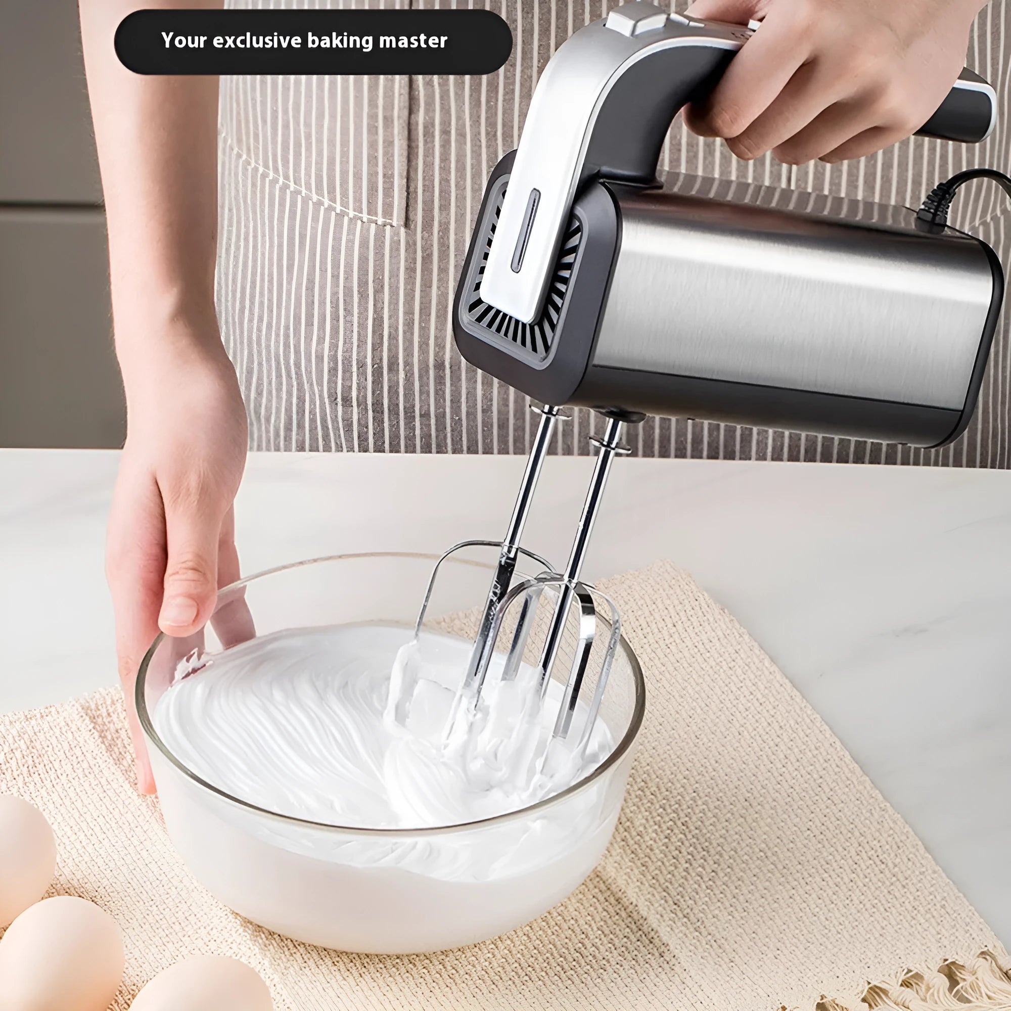 Silver handheld electric whisk with mixing attachments and five speed control dial
