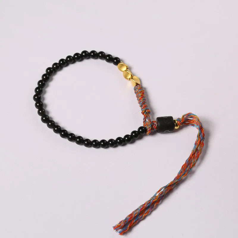 Hand-woven obsidian carrying strap bracelet showing 4mm width and woven texture detail