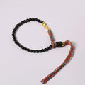 Hand-woven obsidian carrying strap bracelet showing 4mm width and woven texture detail