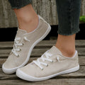 Creamy-white women's low-top fabric casual sneakers with a rubber sole.