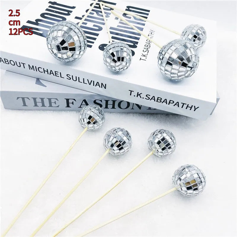 Glass disco ball cake decoration with wooden stick on a birthday cake