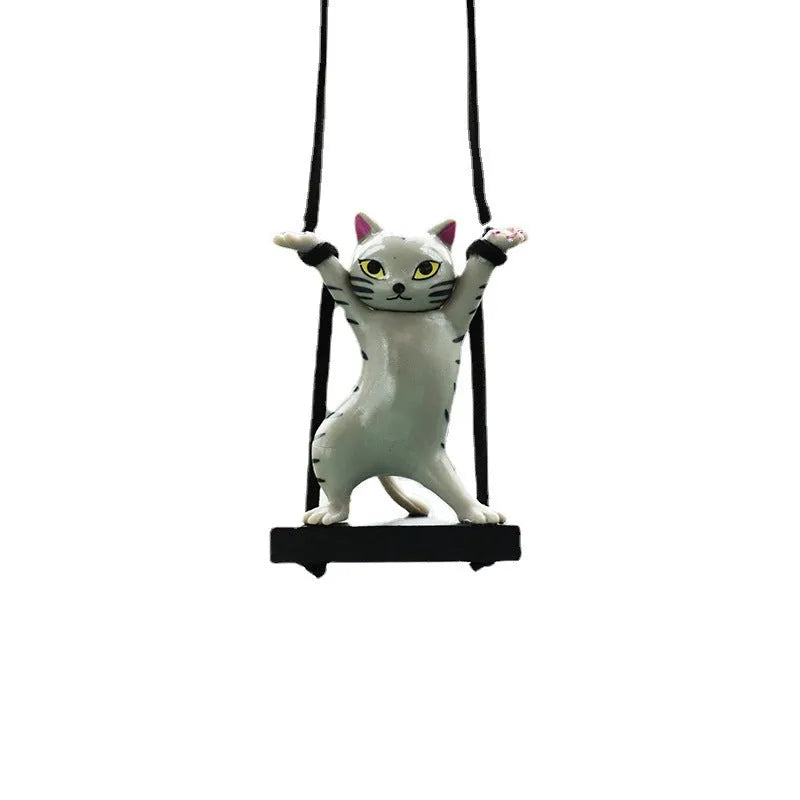 Cartoon-style resin cat pendant on a rope hanger for car interior decoration.