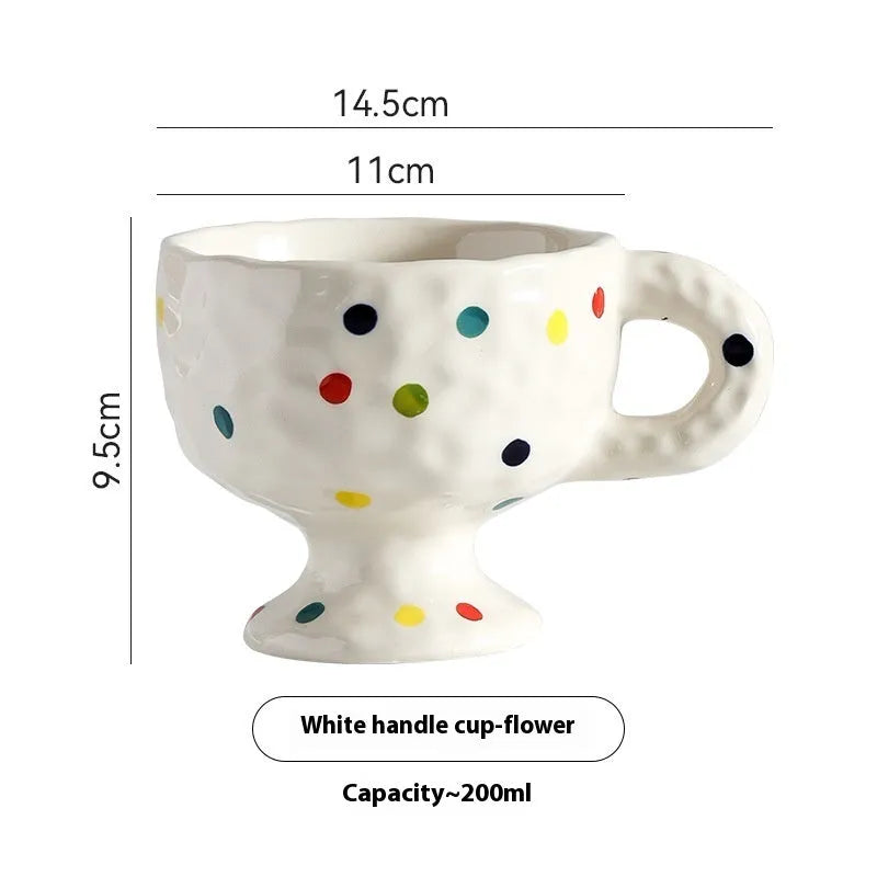 Hand-pinched irregular ceramic mug in a solid colour, shown from the side to display its unique shape.