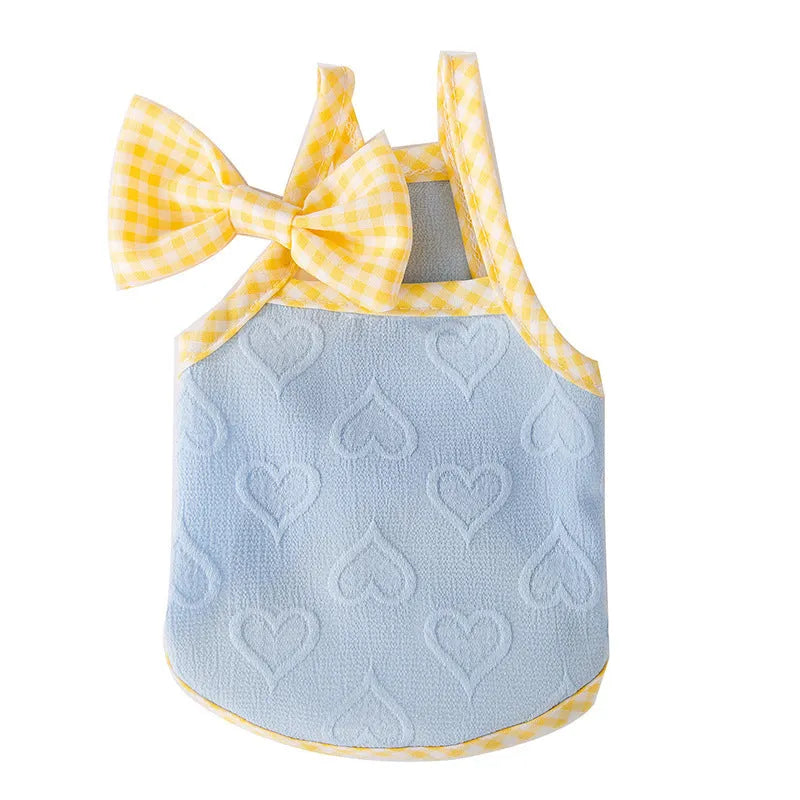 Small dog wearing heart relief texture bow suspenders vest in blue with matching hairband