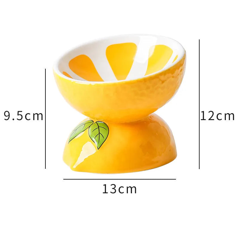 Orange patterned ceramic elevated cat bowl on a wooden floor.