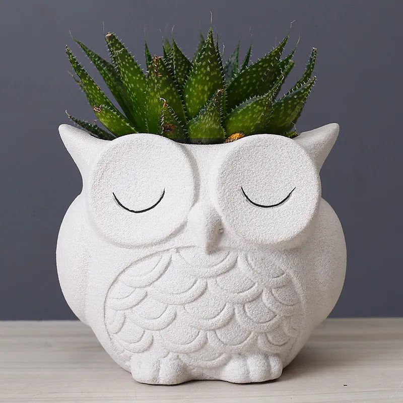 Handmade frosted ceramic owl planter for small succulents, shown in light pink.