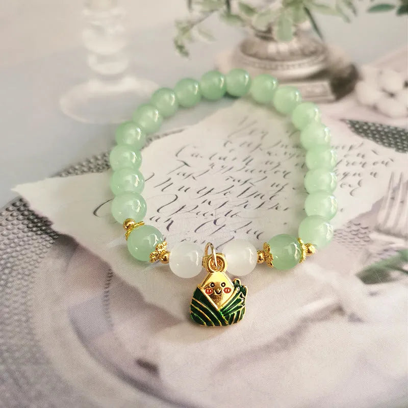 Chinese style handmade glass bead bracelet with bamboo joint elements on a white background.