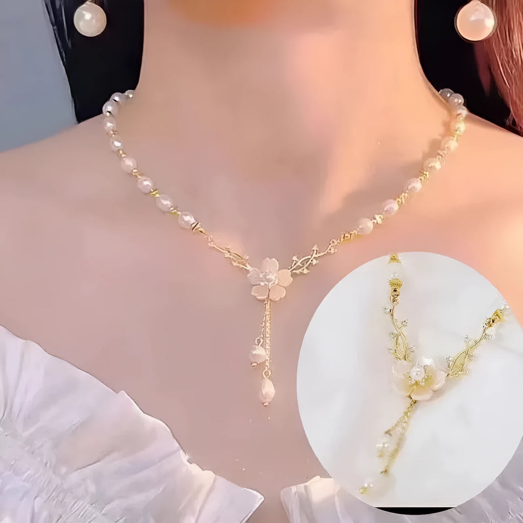 Alloy fashion necklace with pearl flower and rose decoration on a chain.