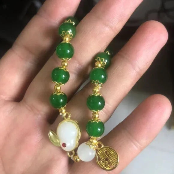Chinese style handmade glass bead bracelet with bamboo joint elements on a white background.