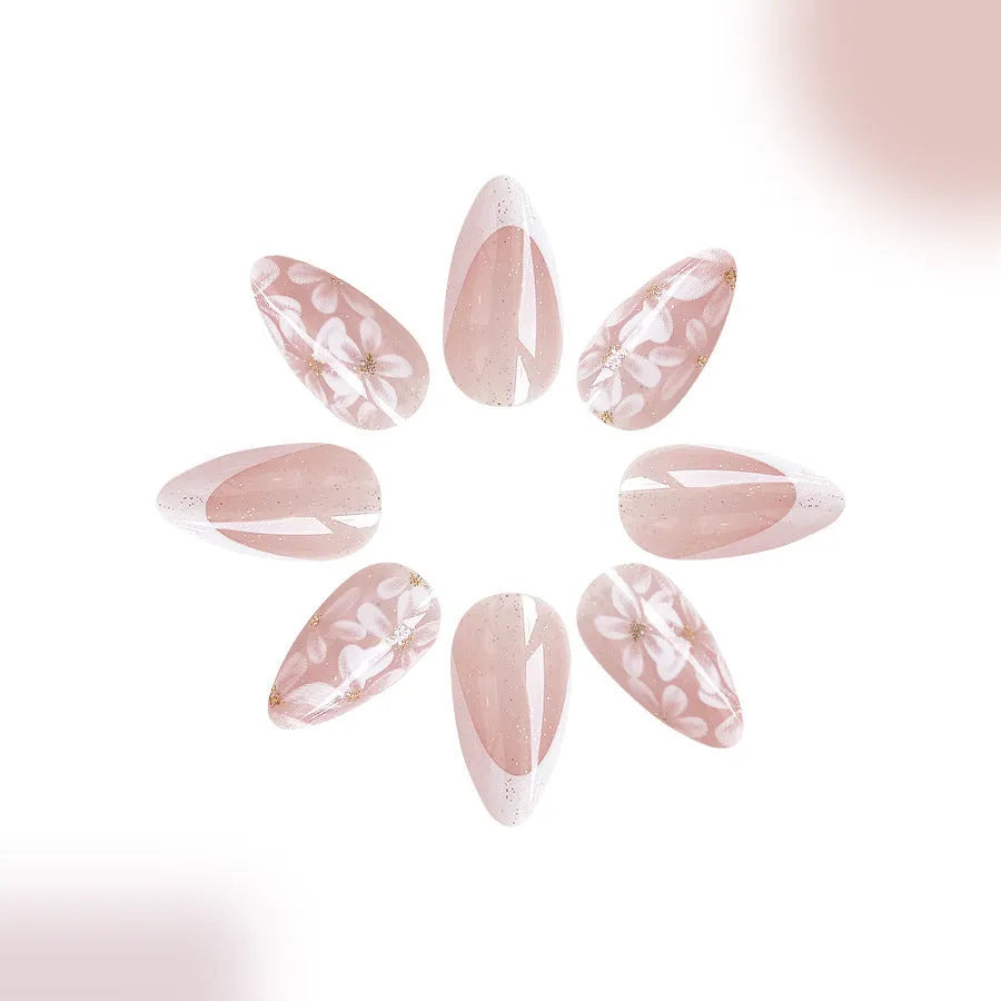 Short almond shaped false nails with glossy finish and glitter flower French tip design colour C625