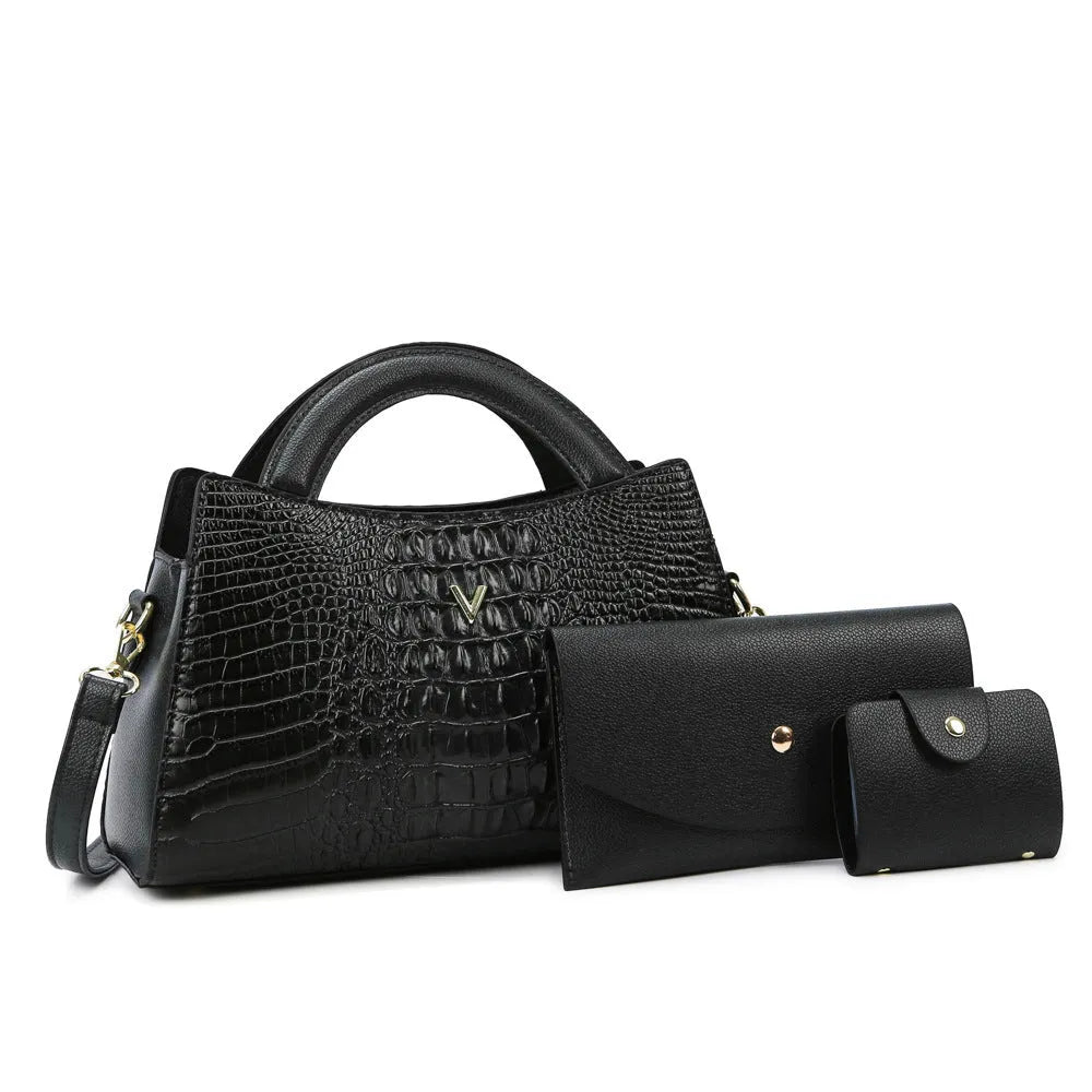 Women's square black crossbody handbag with crocodile pattern texture, showing front zip and adjustable strap.