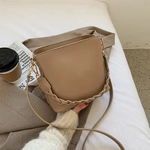Unisex one-shoulder crossbody bucket bag in woven PU leather, shown in khaki colour.