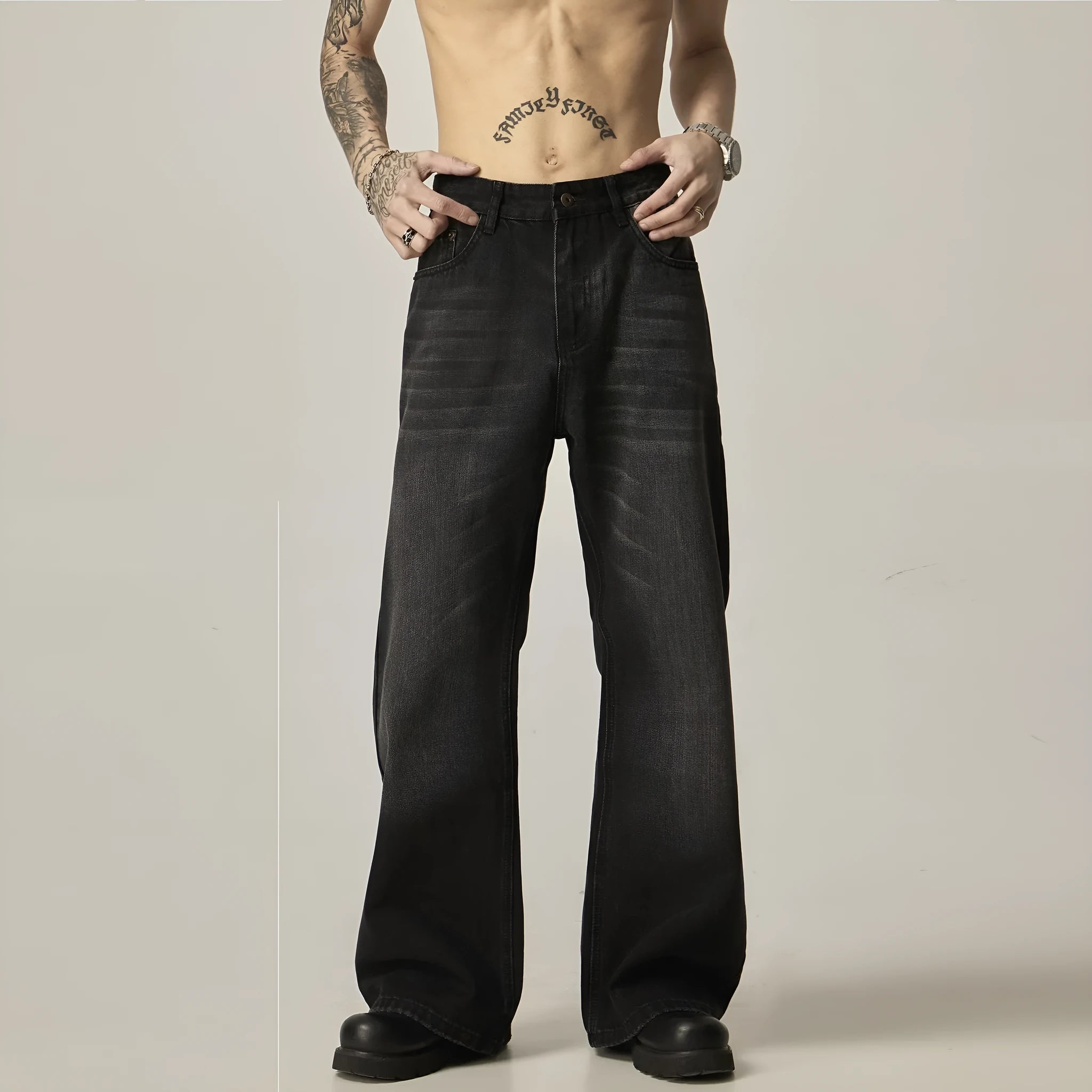 Black loose straight leg retro jeans on a hanger, showing zipper fly detail.