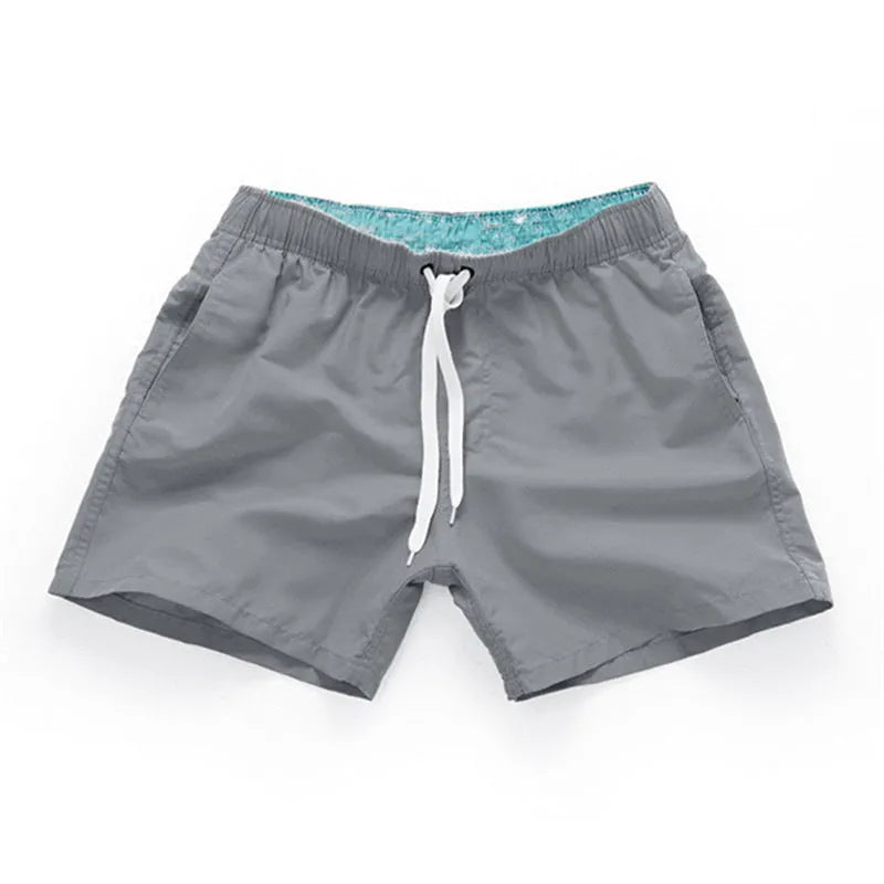 Men's polyester beach shorts in multiple colours with straight leg opening, suitable for surfing and swimming