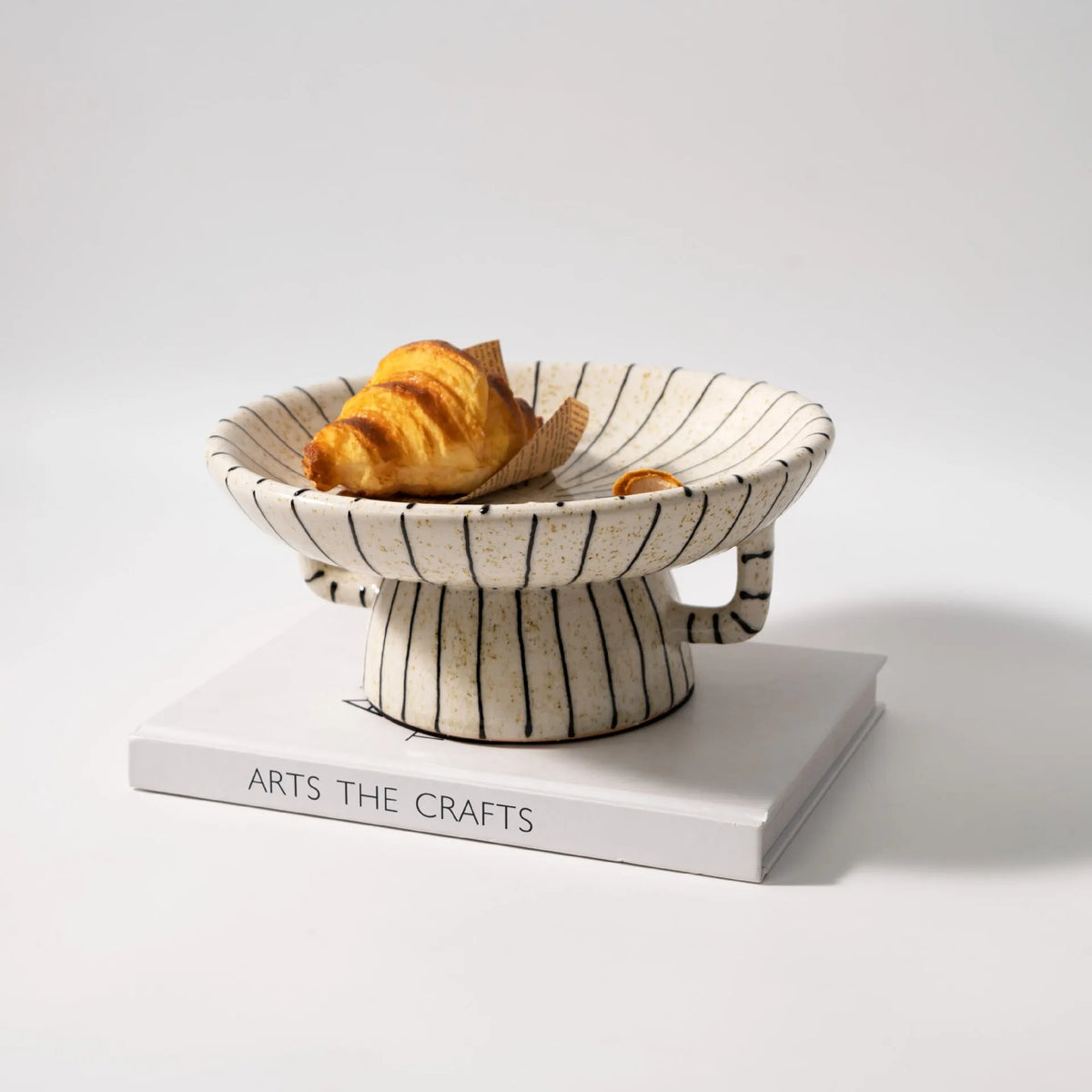 Black and white striped retro synthetic resin dessert plate on a table.