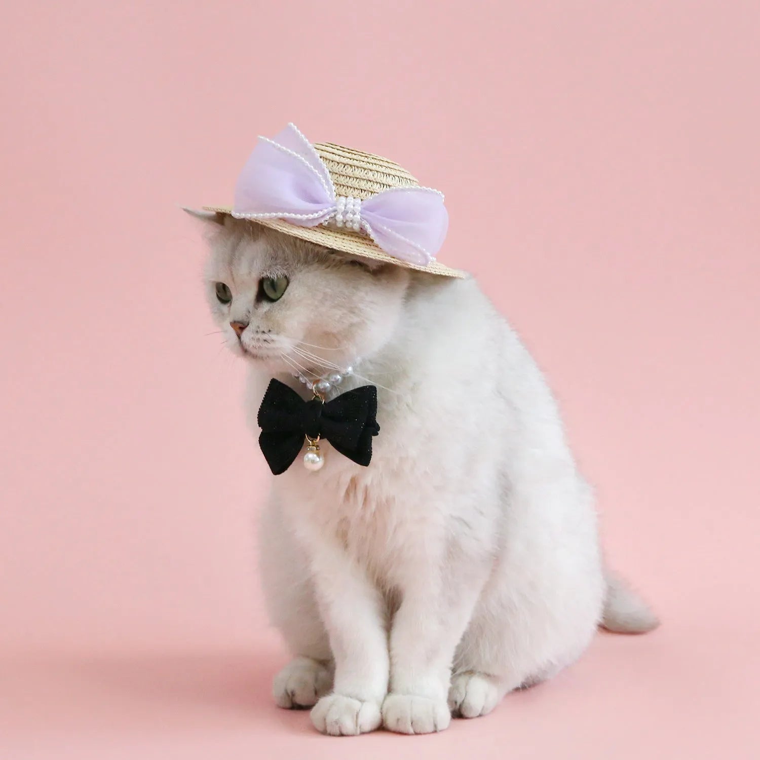 Woven straw hat for cats with pearl butterfly bow in princess style, shown in pink colour
