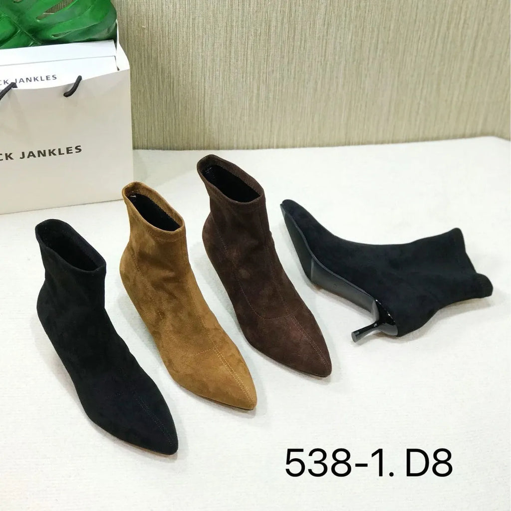 Women's black pointed toe ankle boots with stiletto heel on a plain background