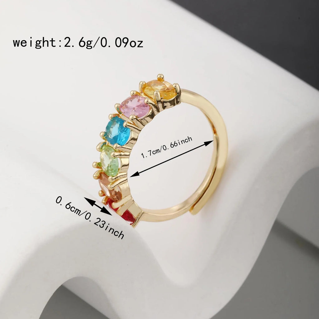 Gold coloured adjustable zircon ring for women on a simple background