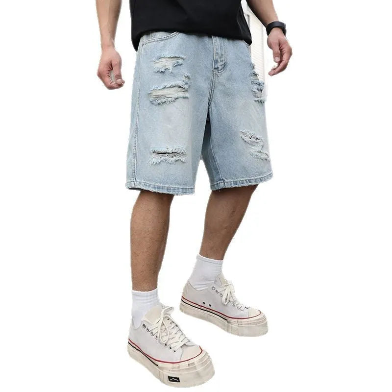 Light blue loose-fit ripped denim shorts with distressed details on a straight-leg silhouette.