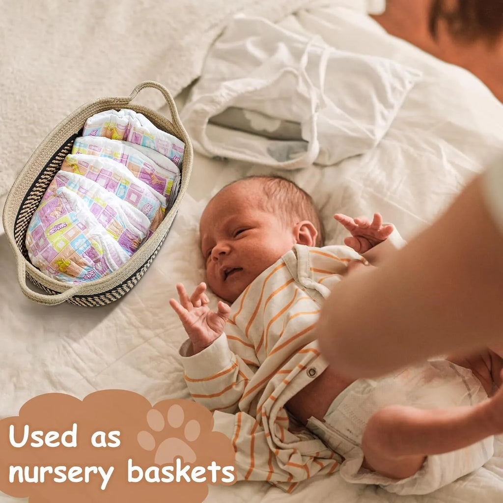 Light beige handmade woven cotton rope storage basket with wood accents and a handle.