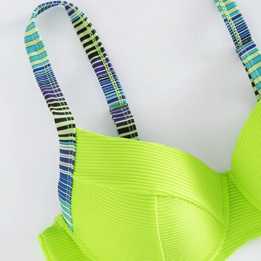 Green women's halter bikini set with sleeveless top and split briefs on a mannequin.
