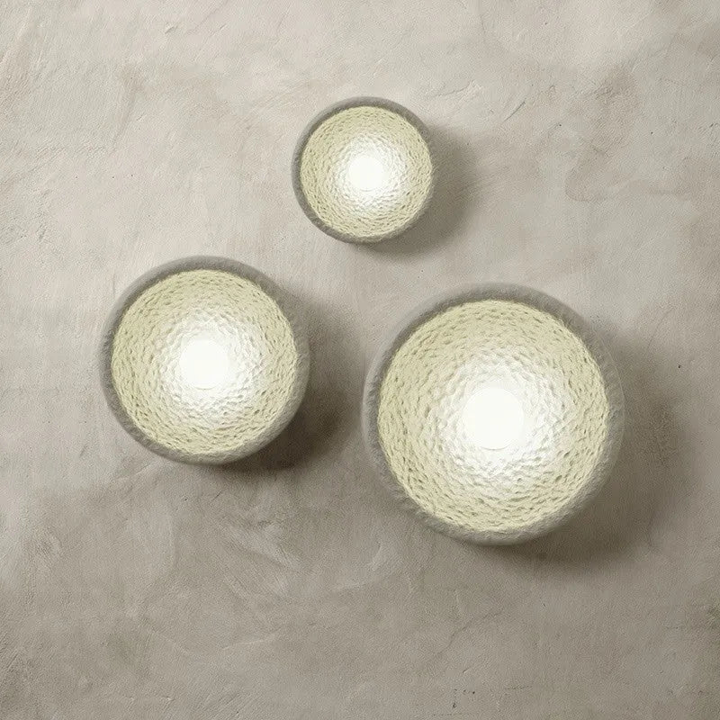 Japanese-style modern simple wall lamp with a round resin shade in warm white light.