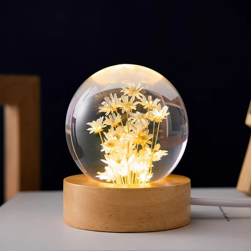 Clear resin ball night light with a dandelion inside on a beech wood base.