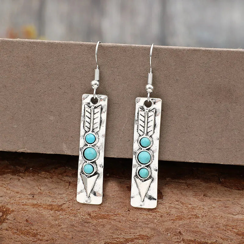 Silver geometric drop earrings with turquoise stone inlay on long strip design