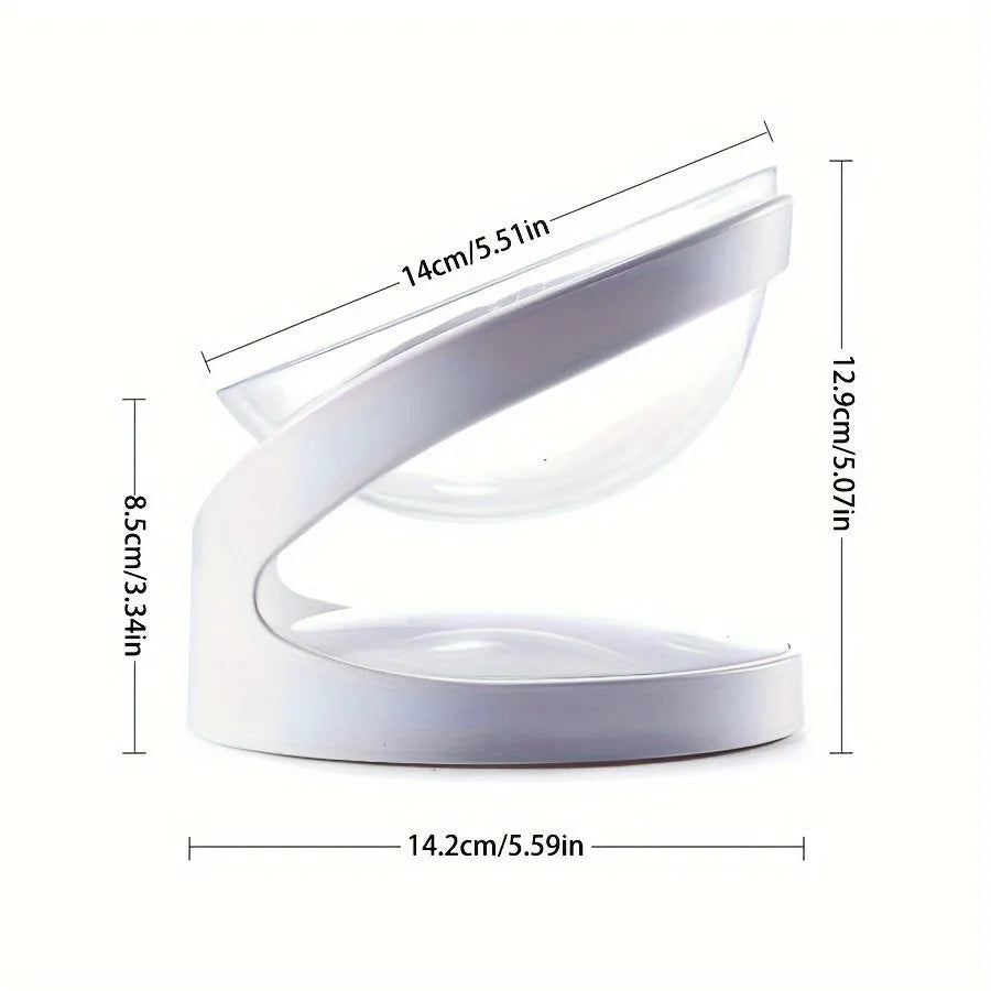 White clear plastic tilted cat food bowl on a flat surface.