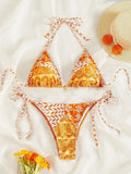 Women's green split bikini bandage swimsuit with printed stitching on a model