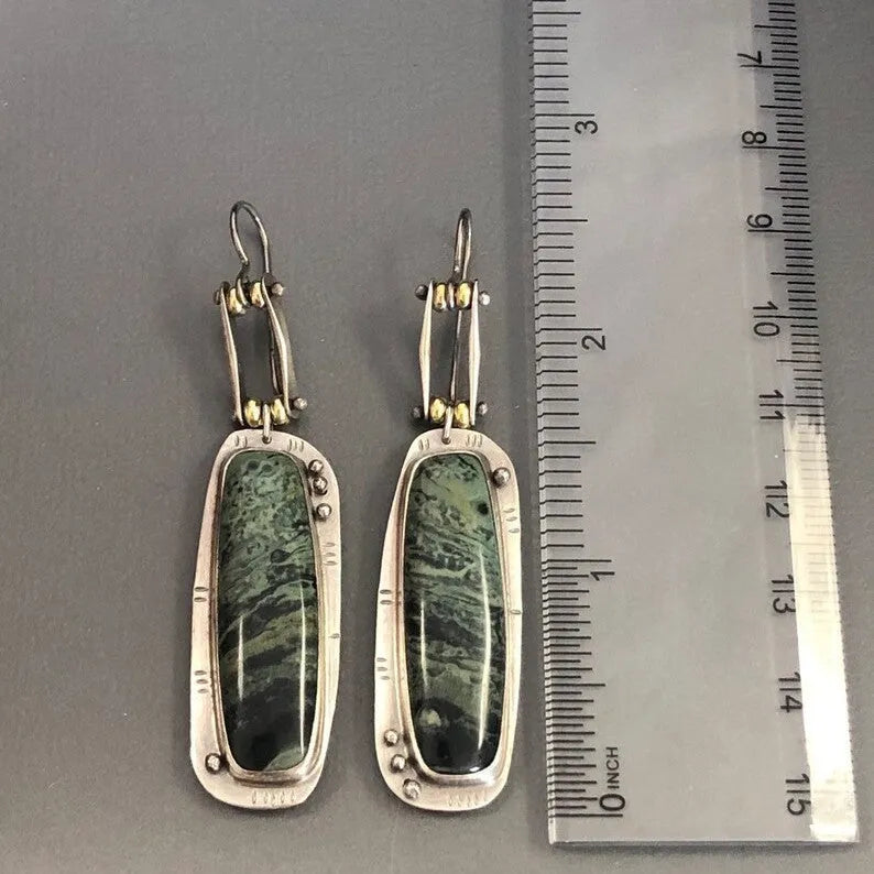 Two-colour marble pattern geometric alloy drop earrings on a white background.
