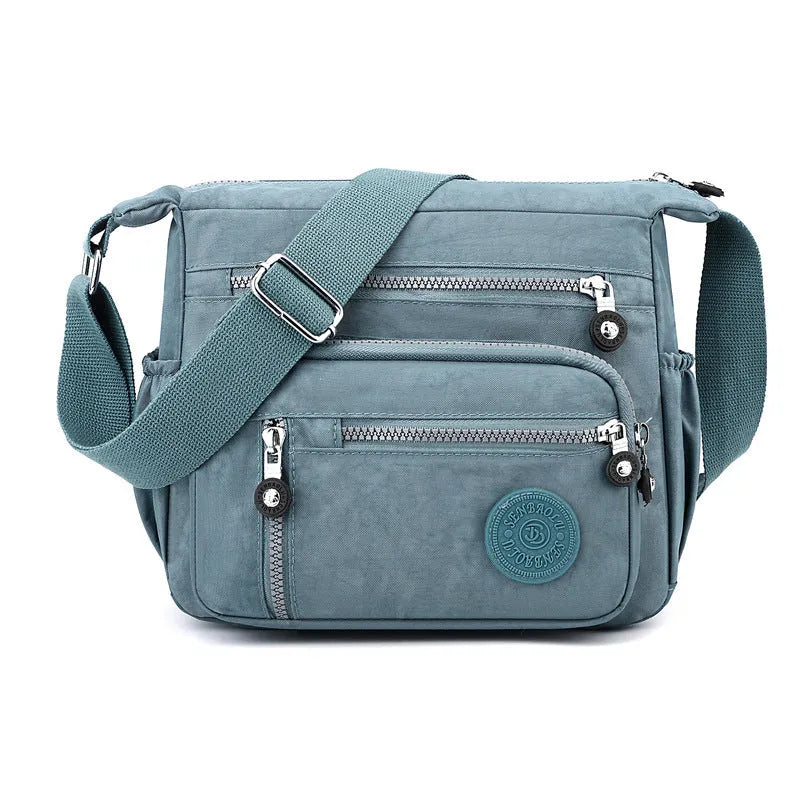 Grey soft nylon messenger bag with single shoulder strap showing square vertical shape