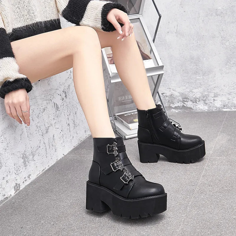 Black women's gothic punk Martin boots with bat buckle and side zipper on a thick heel.