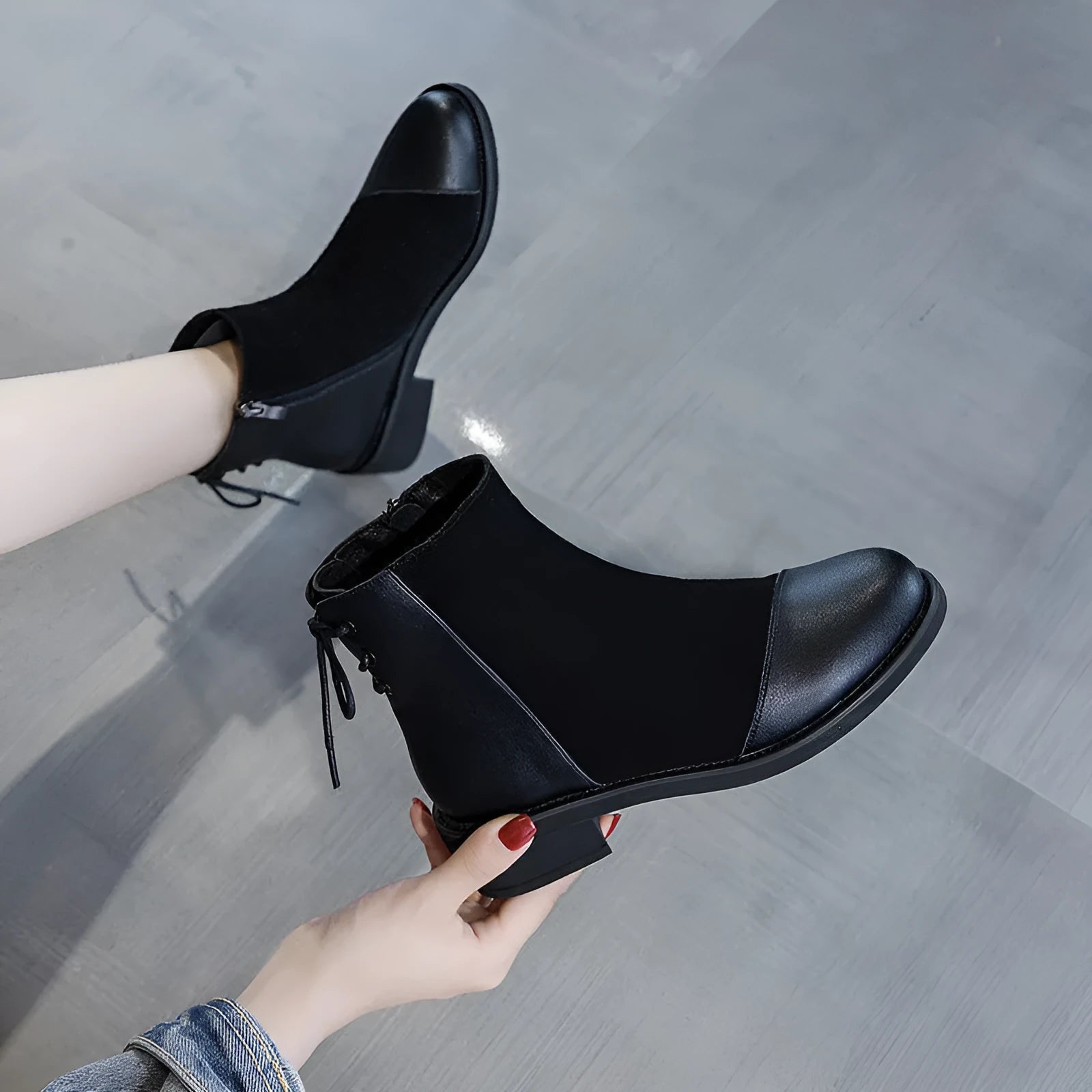 Women's black knee-high Martin boots with side zip and decorative bow detail