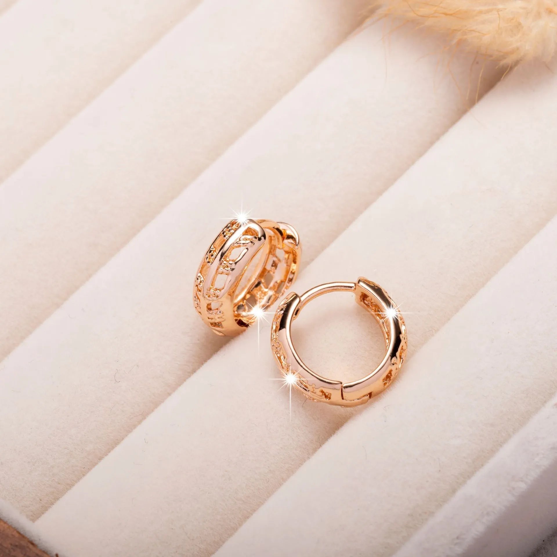 Copper hollowed-out leaf and heart shaped earrings with rose gold finish showing geometric patterns