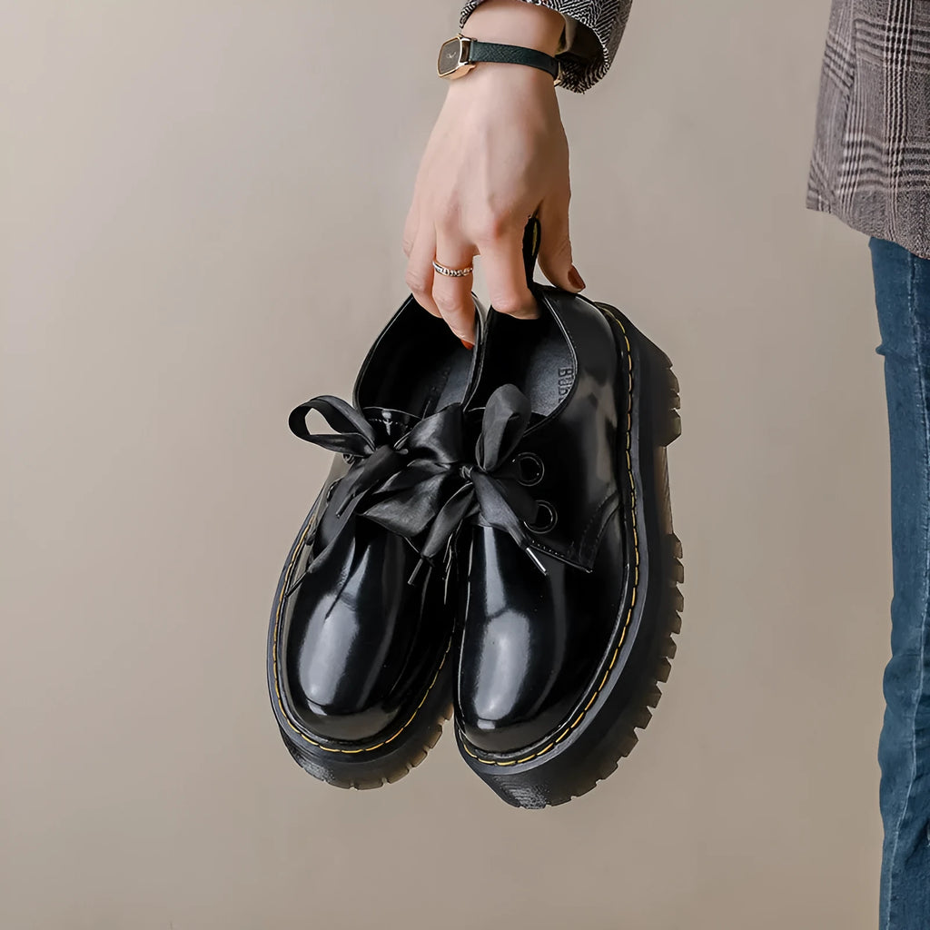Women's thick soled leather shoes with ribbon details in black and white colour options