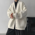 Women's black knitted cardigan coat with long sleeves and loose fit