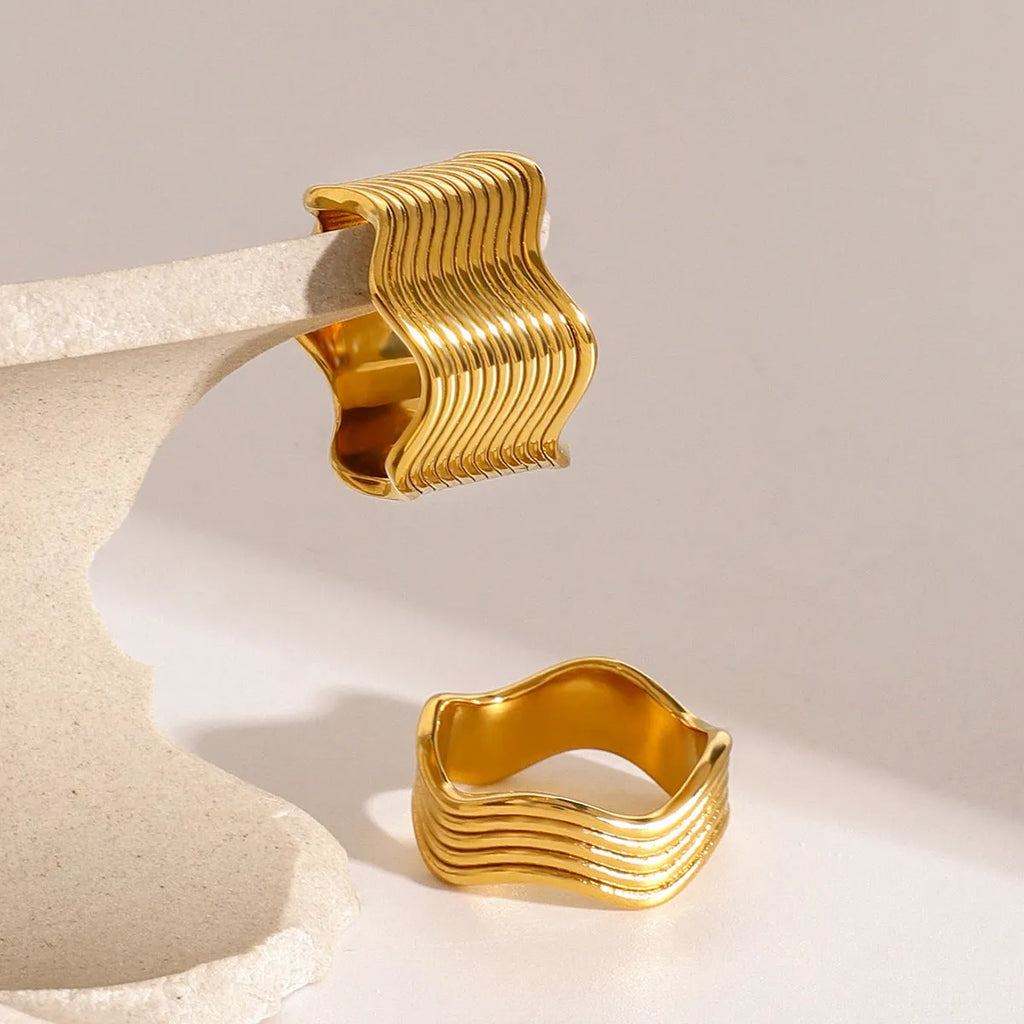 Stainless steel wide band geometric wave ring in Korean style.