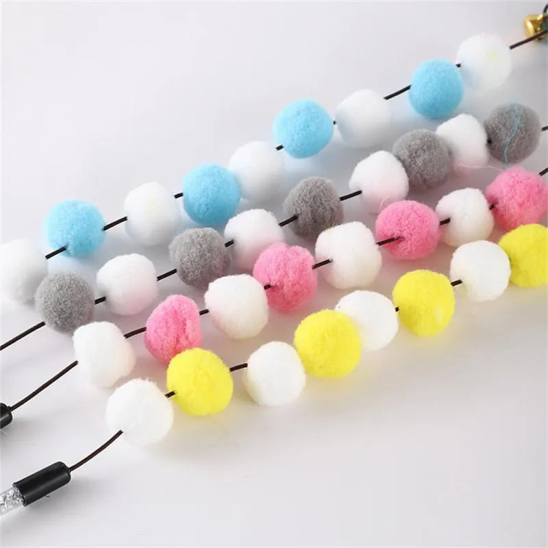 Colourful cat teaser toy stick with acrylic pompon, feathers, and a bell on a 31cm rod