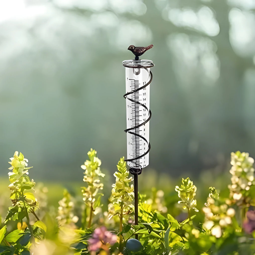 Cast iron bird-shaped rain gauge with glass measurement cylinder for garden weather tracking