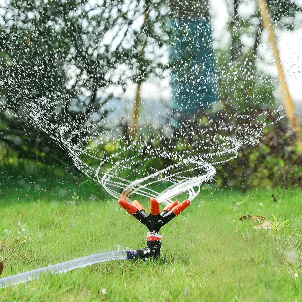 Orange plastic garden insert sprinkler with rotating water spray, 14 x 26.5cm, single nozzle