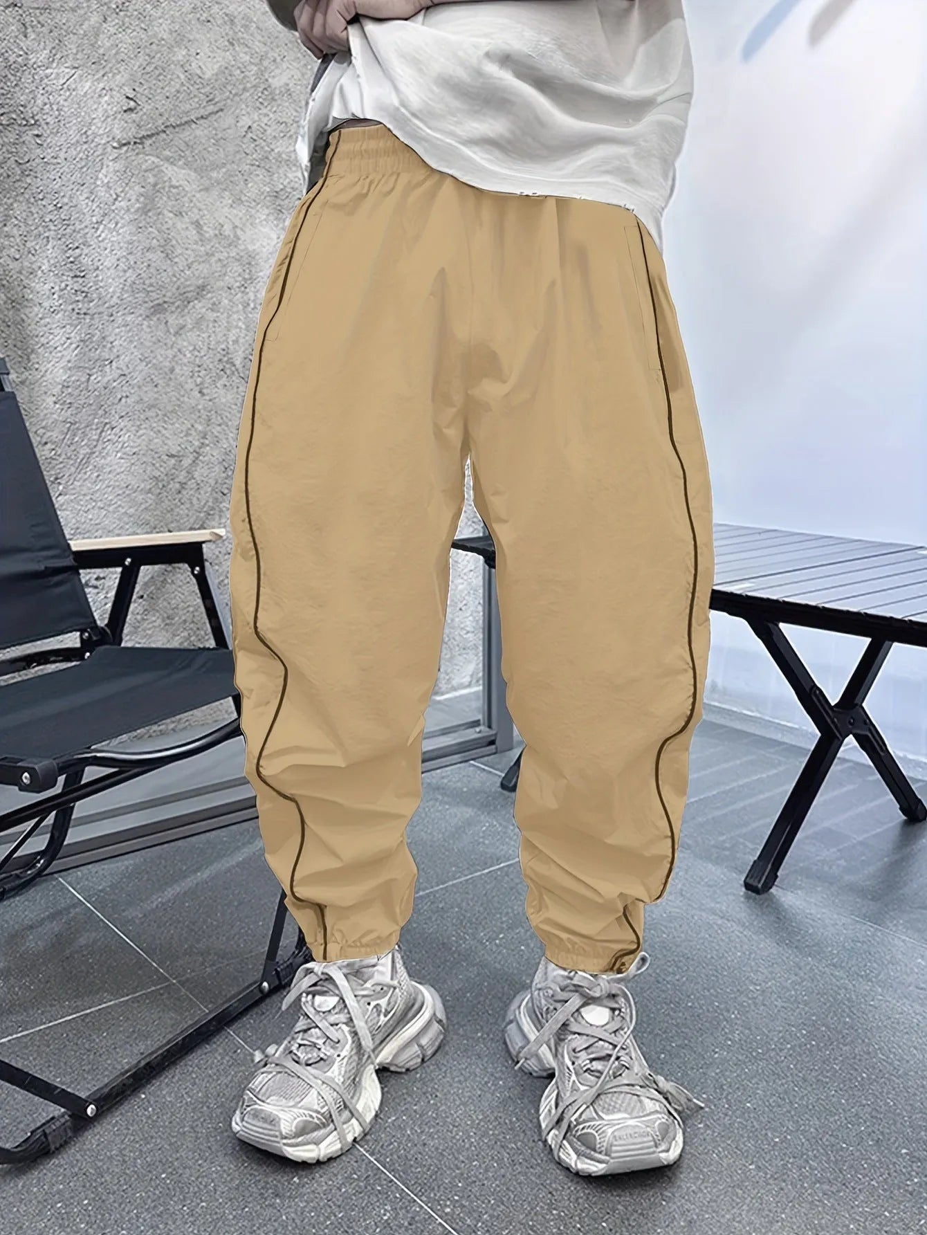 Men's blue bamboo fibre sports trousers with a loose, cropped fit and elastic waist.