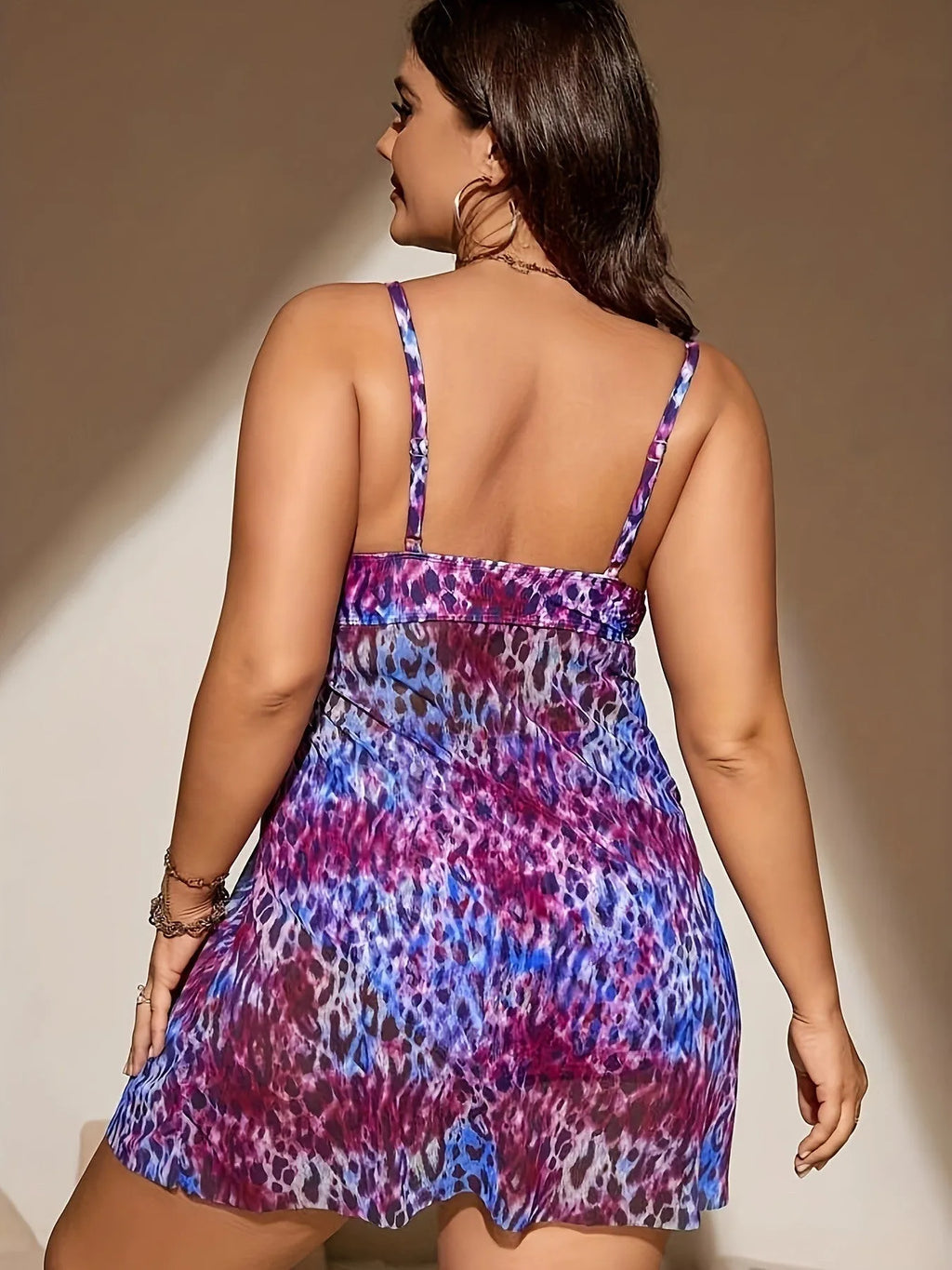 Plus size woman wearing a blue split bikini set, featuring a sleeveless top and shorts, for swimming.
