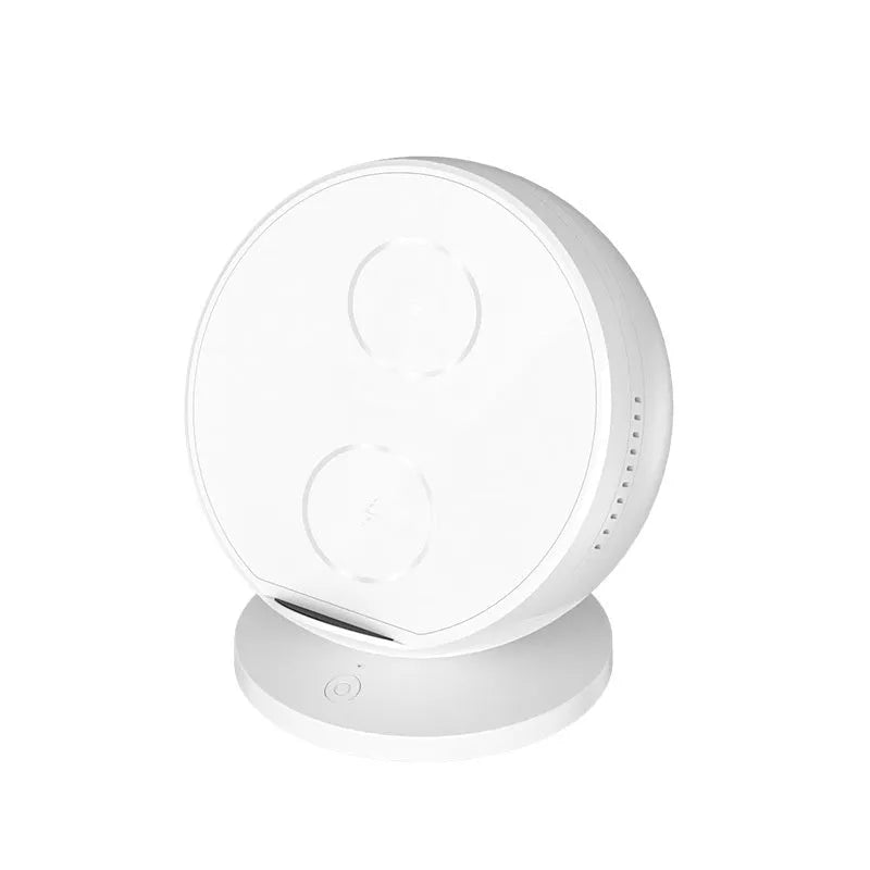 Black ABS plastic wireless phone charger holder with integrated Bluetooth speaker on a wooden desk.